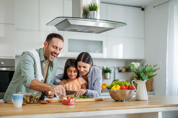 Familia na cozinha preparando alimentos
